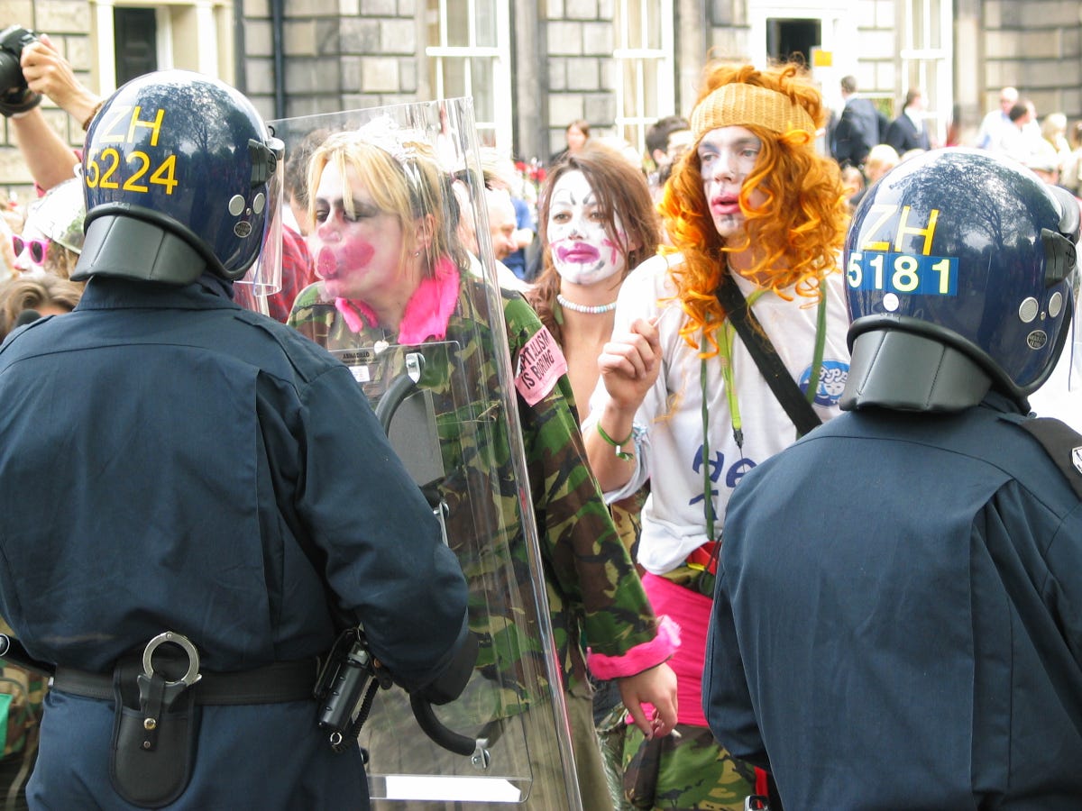 A famous photo showing a clown confusing a police officer with love messages.